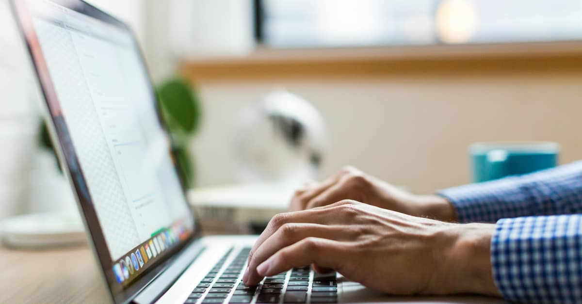 Person typing on a laptop at a desk