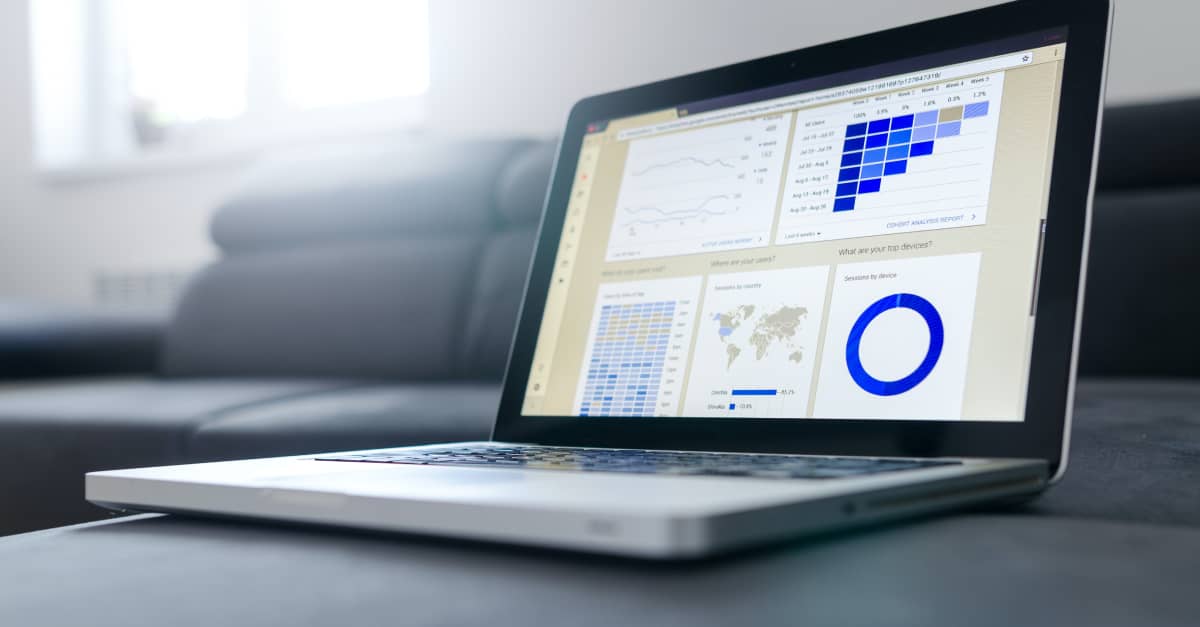 Laptop on a sofa showing an analytics dashboard with charts, related to revenue marketing insights