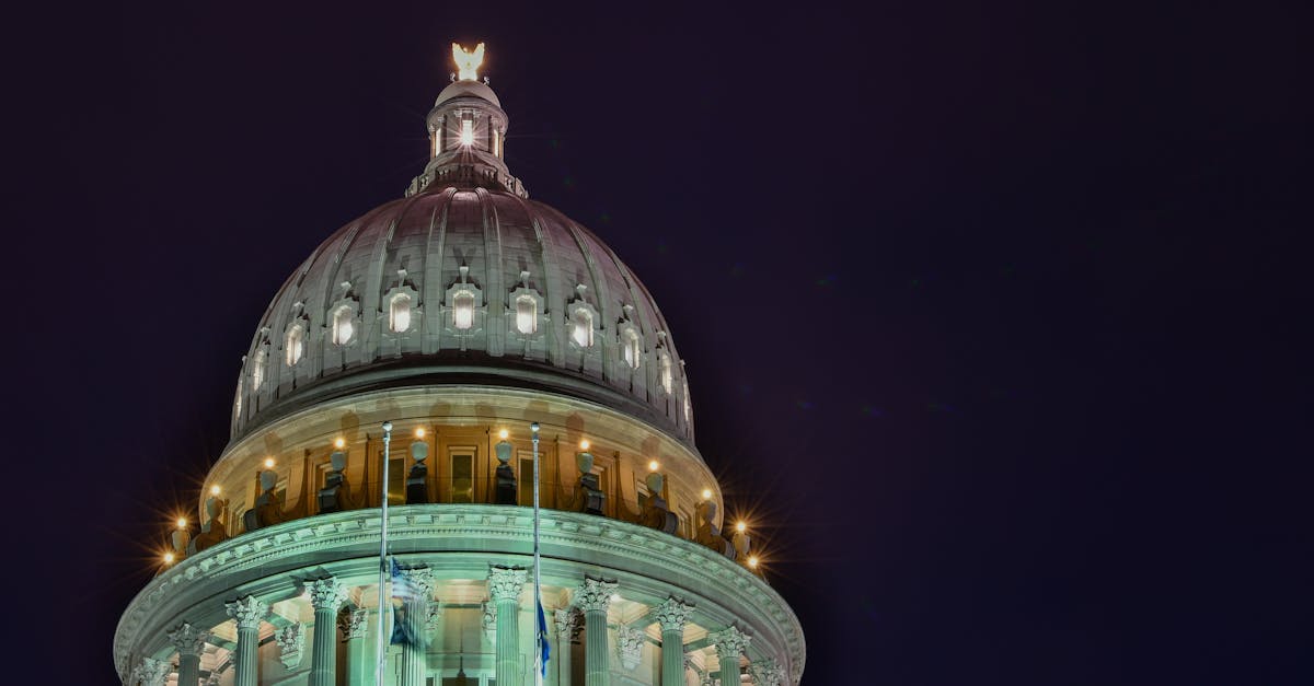 A stunning view of an illuminated capitol building dome against the night sky.