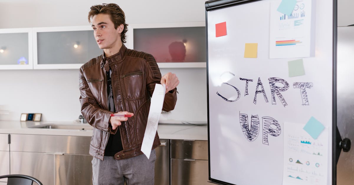 A young entrepreneur gives a presentation on startup strategies indoors with a flip chart.