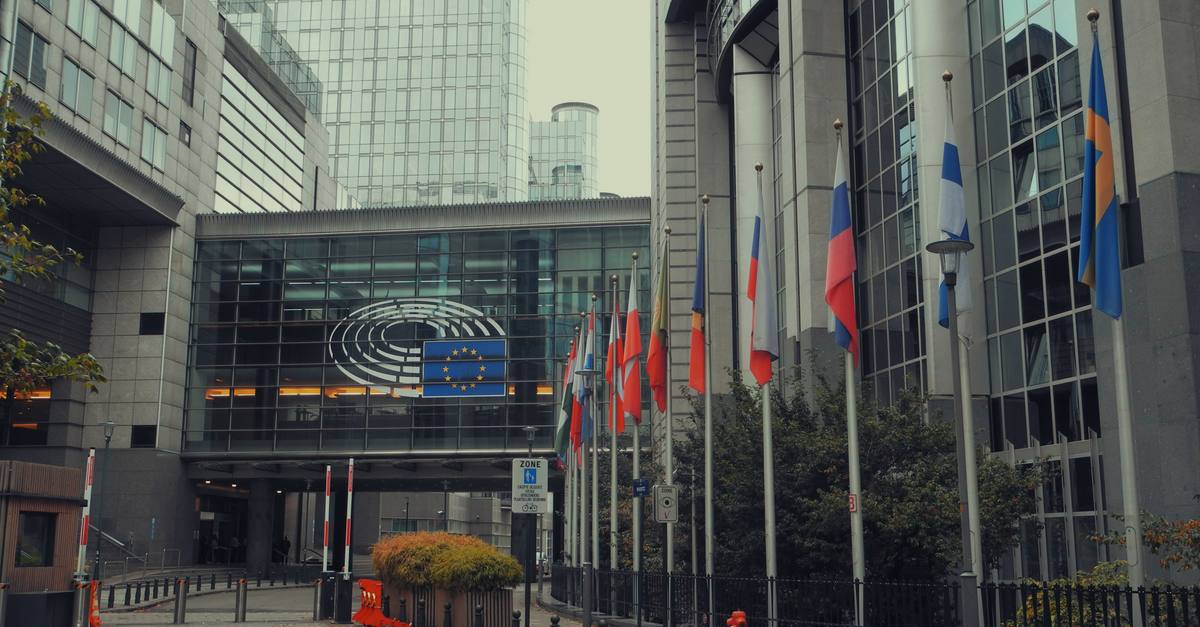 Exterior view of European Parliament with EU flags in Brussels