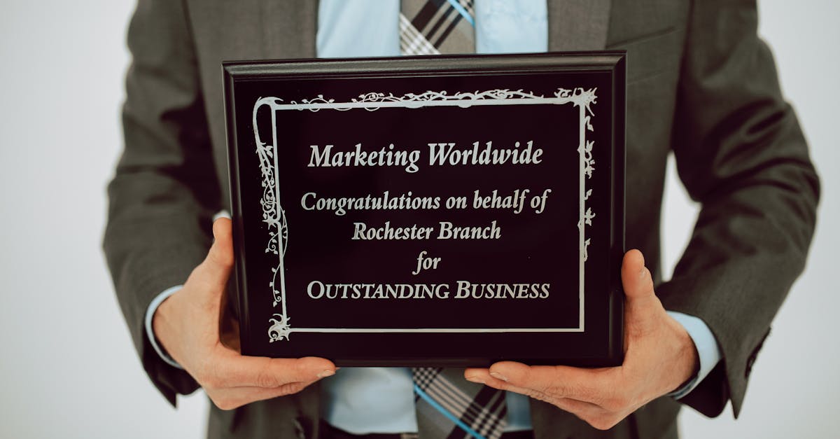 Businessperson holding an award for outstanding business achievement in formal attire.
