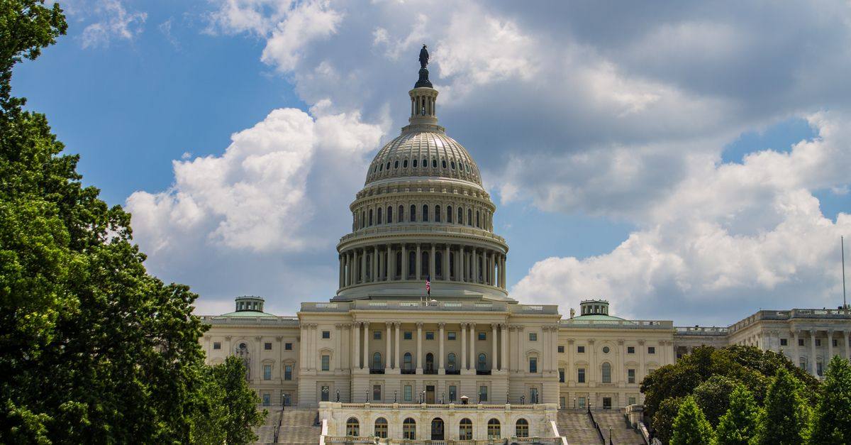 A stunning view of the iconic United States Capitol under a blue sky in Washington, D.C.