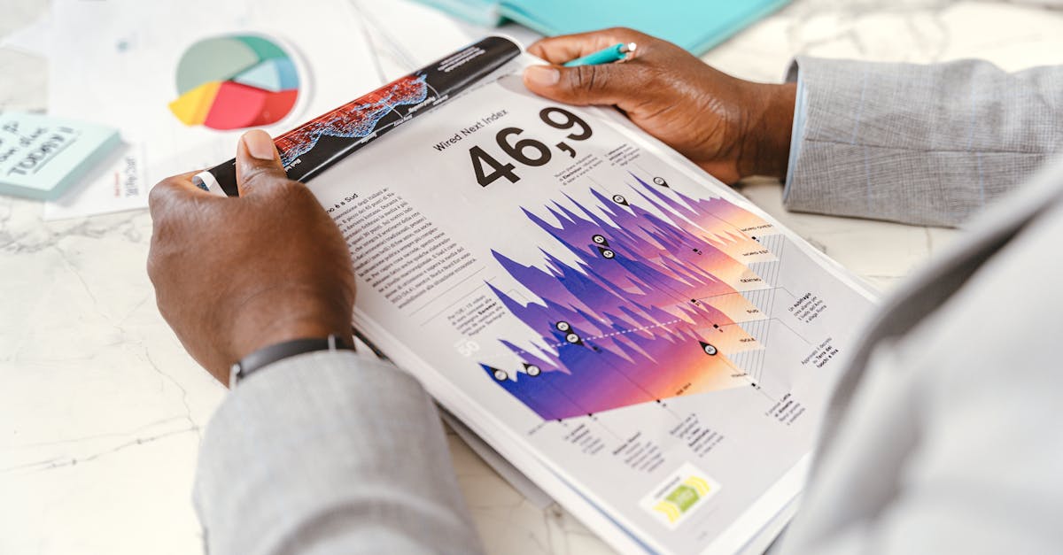Close-up of a businessman analyzing colorful statistical data in an office setting.