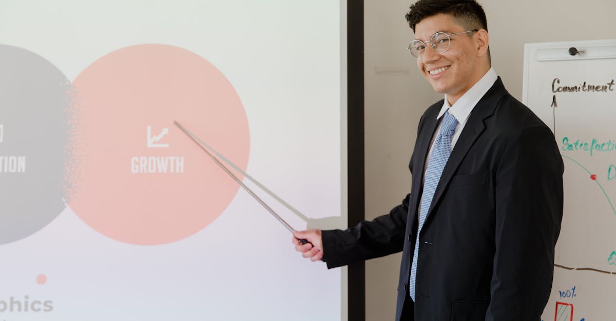 Smiling businessman presenting growth strategy in a modern meeting room.