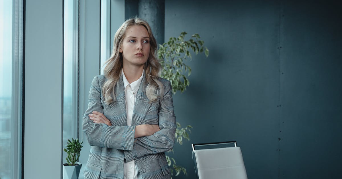 A professional businesswoman stands confidently in a modern office, exuding leadership and determination.