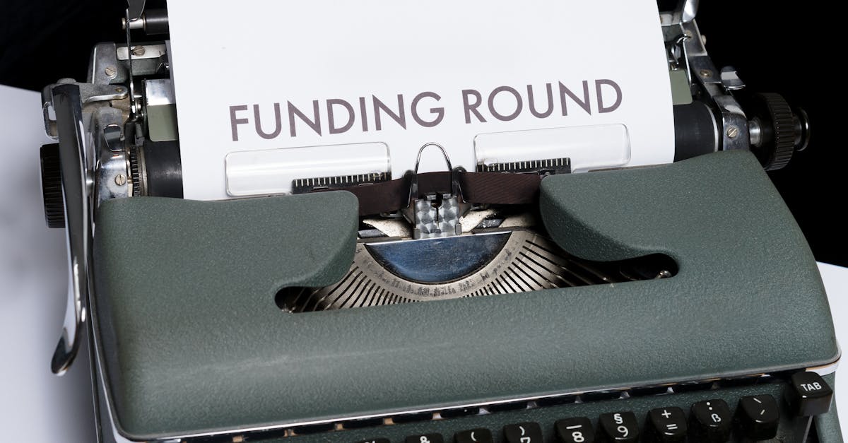 A vintage typewriter displaying the text 'Funding Round,' symbolizing investment and business planning.