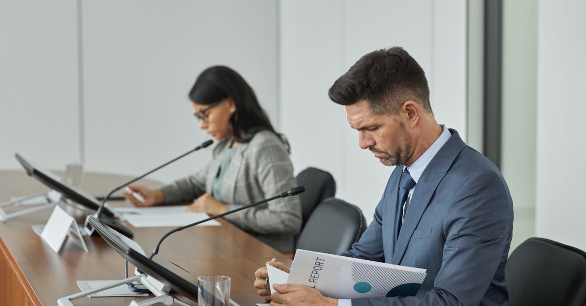 Business professionals in a conference setting, focusing on documents and reports.