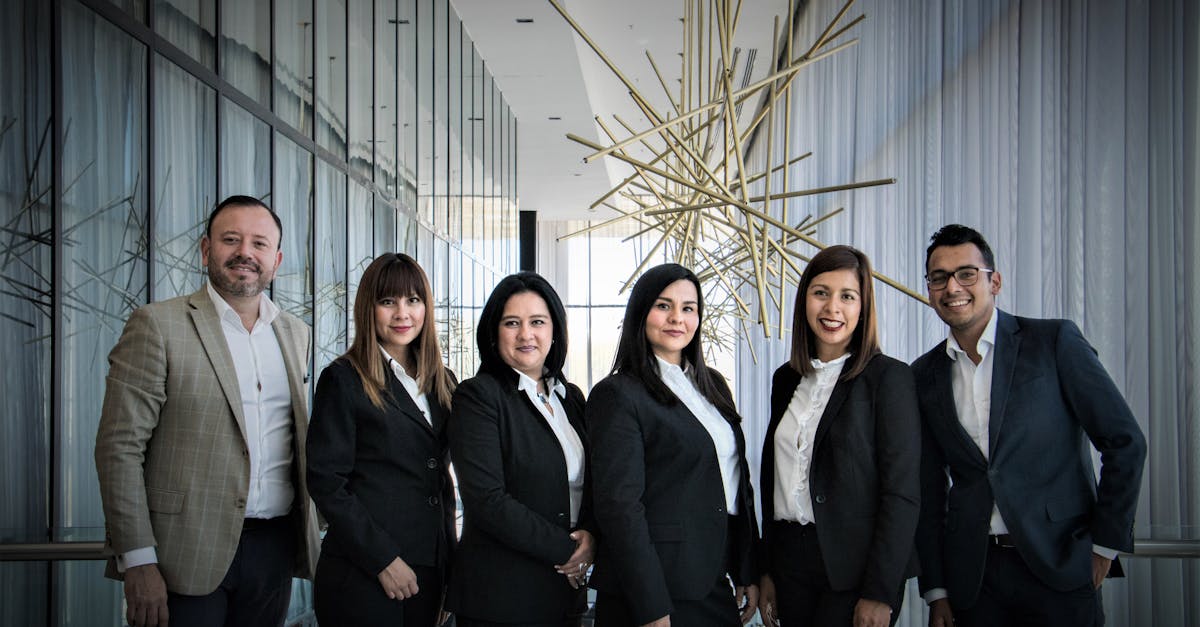 Diverse business team in formal attire posed in modern office.
