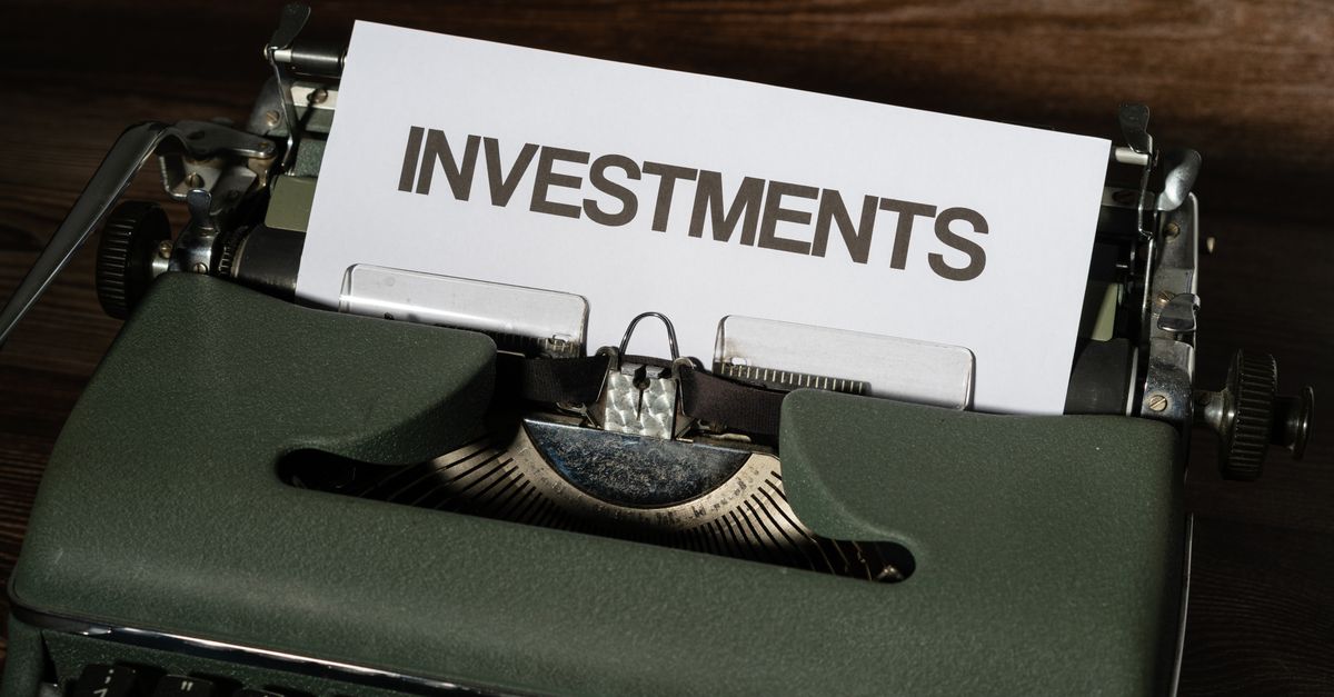 Close-up of a vintage typewriter with a paper labeled 'INVESTMENTS'.