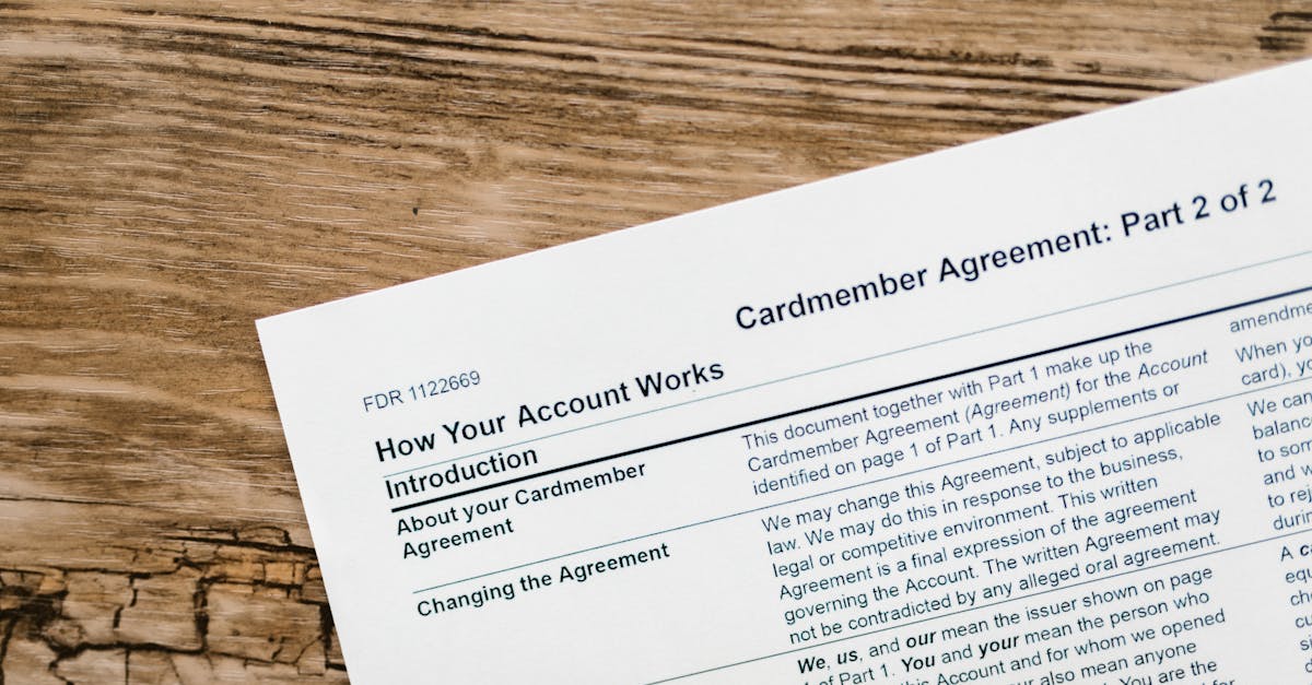 Close-up of a credit card agreement document on a textured wooden desk.