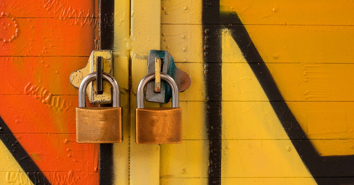 Close-up of two brass padlocks securing a vibrant graffiti-painted door, symbolizing security.