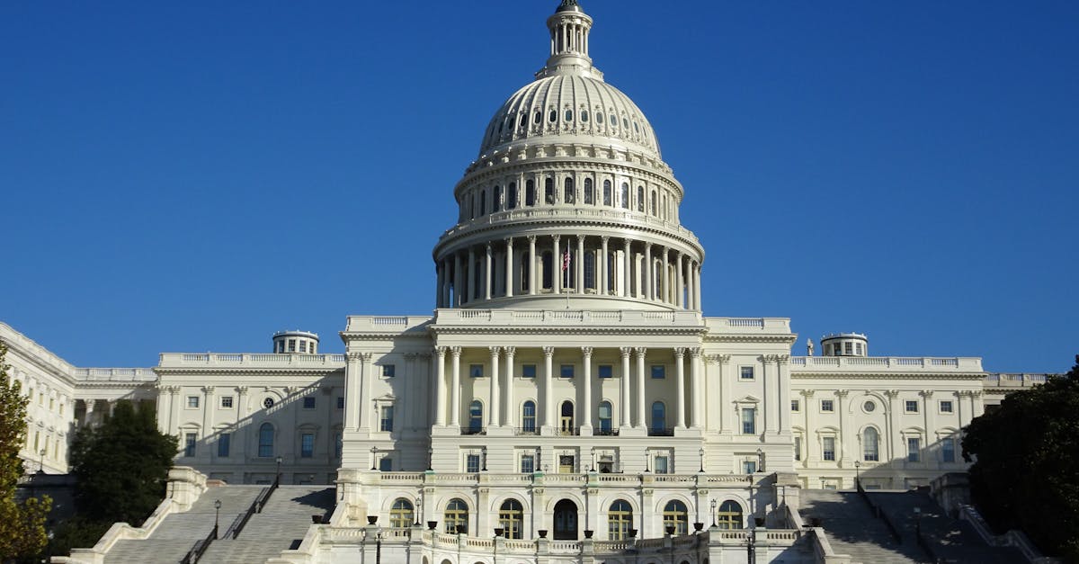 Stunning facade of the iconic United States Capitol in Washington D.C. against a clear blue sky.