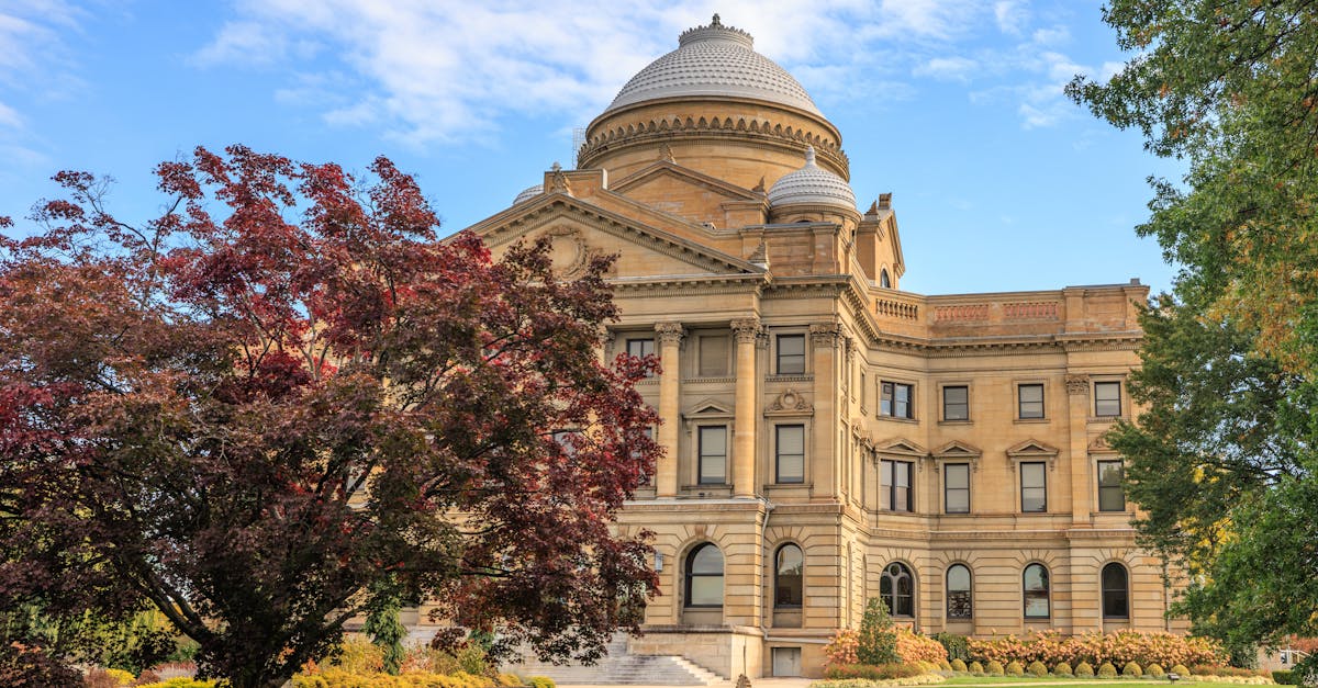 Elegant view of the Luzerne County Courthouse surrounded by autumn foliage under a clear blue sky.