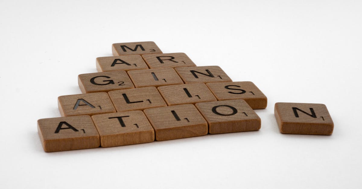 Wooden Scrabble tiles spelling 'IMAGINATION' arranged on a white background.