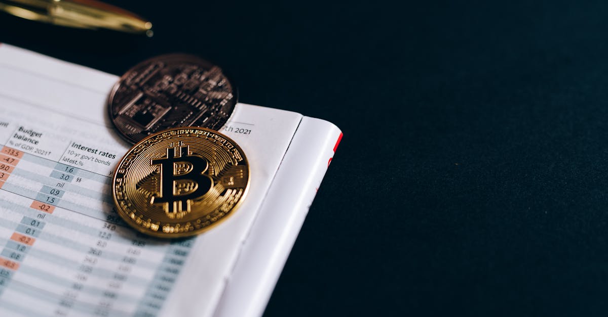 Close-up of Bitcoin coins on a financial report on a dark surface.