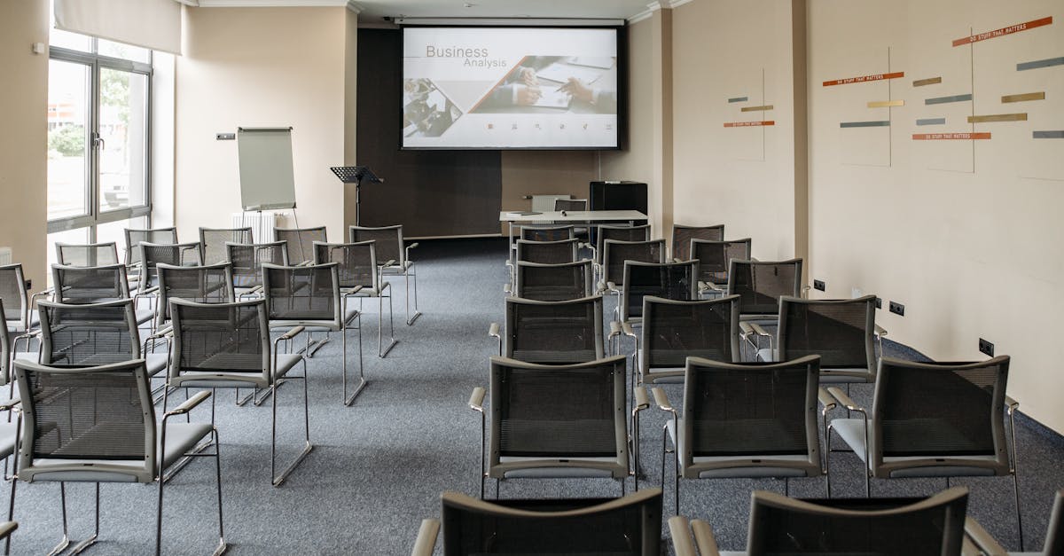 Empty conference room with chairs and a presentation screen setup for business meetings.
