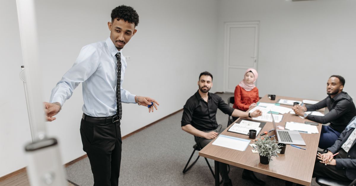 A diverse team collaborates in a modern office setting, showcasing teamwork and communication.