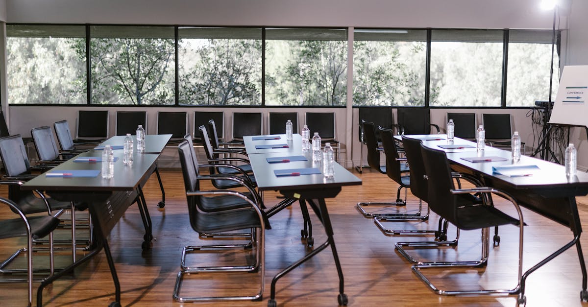 An empty conference room with sleek furniture, ready for a meeting. Bright and professional setting.