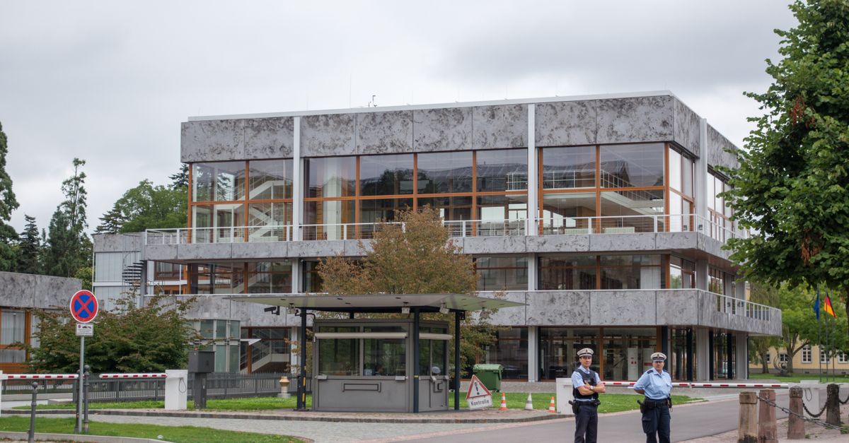 Modern building exterior in Karlsruhe, Germany, with security presence.