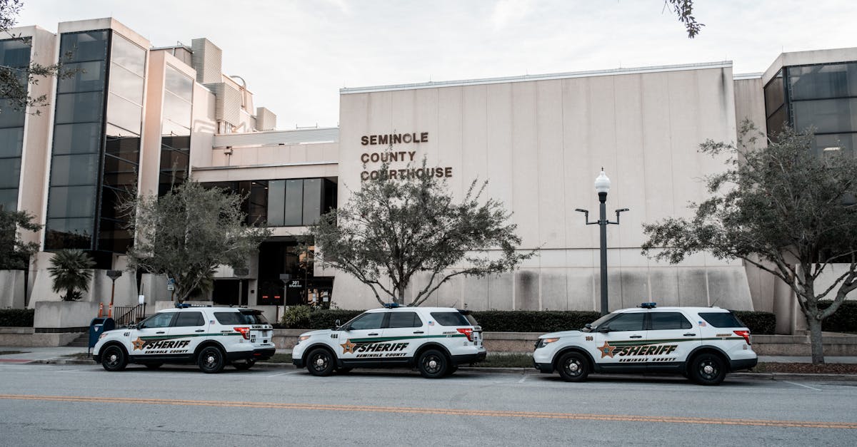 Sheriff vehicles parked in front of Seminole County Courthouse during the day.