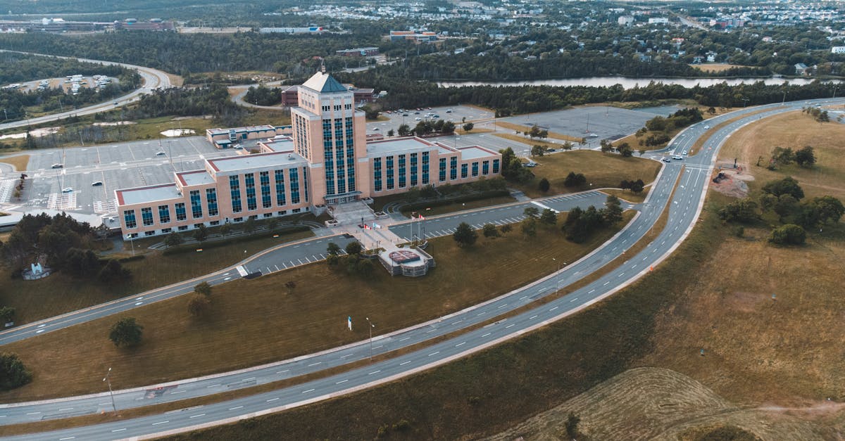 Aerial shot of the Confederation Building in Newfoundland with surrounding landscape and roads.