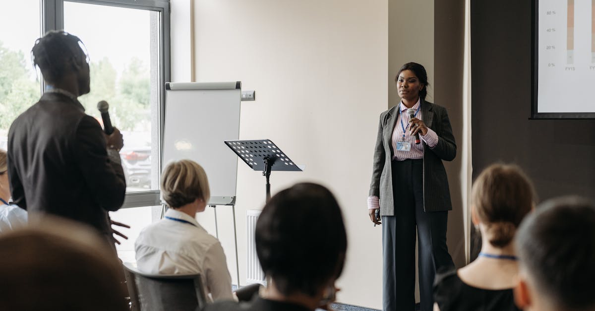 Professional business conference presentation with diverse participants engaging in communication.