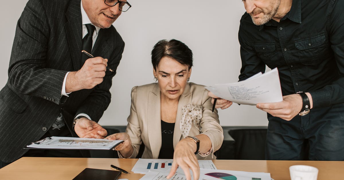 Business team collaborates on financial strategies during an office meeting. Engaged discussion over reports.