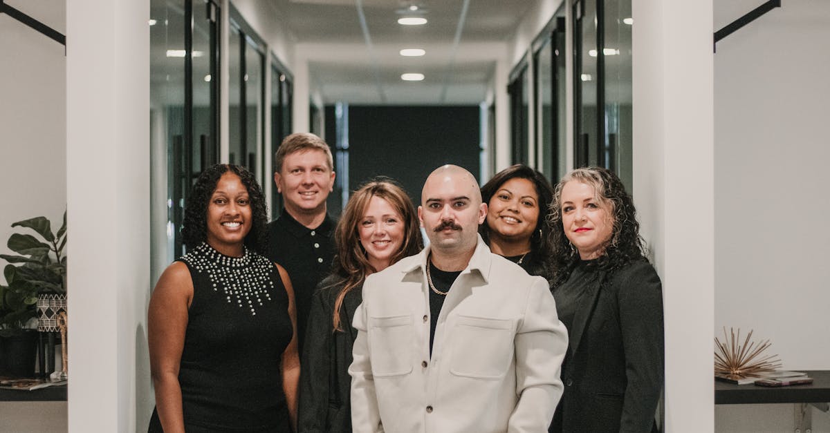 Diverse team of professionals posing in a modern office hallway in Greenville, SC.