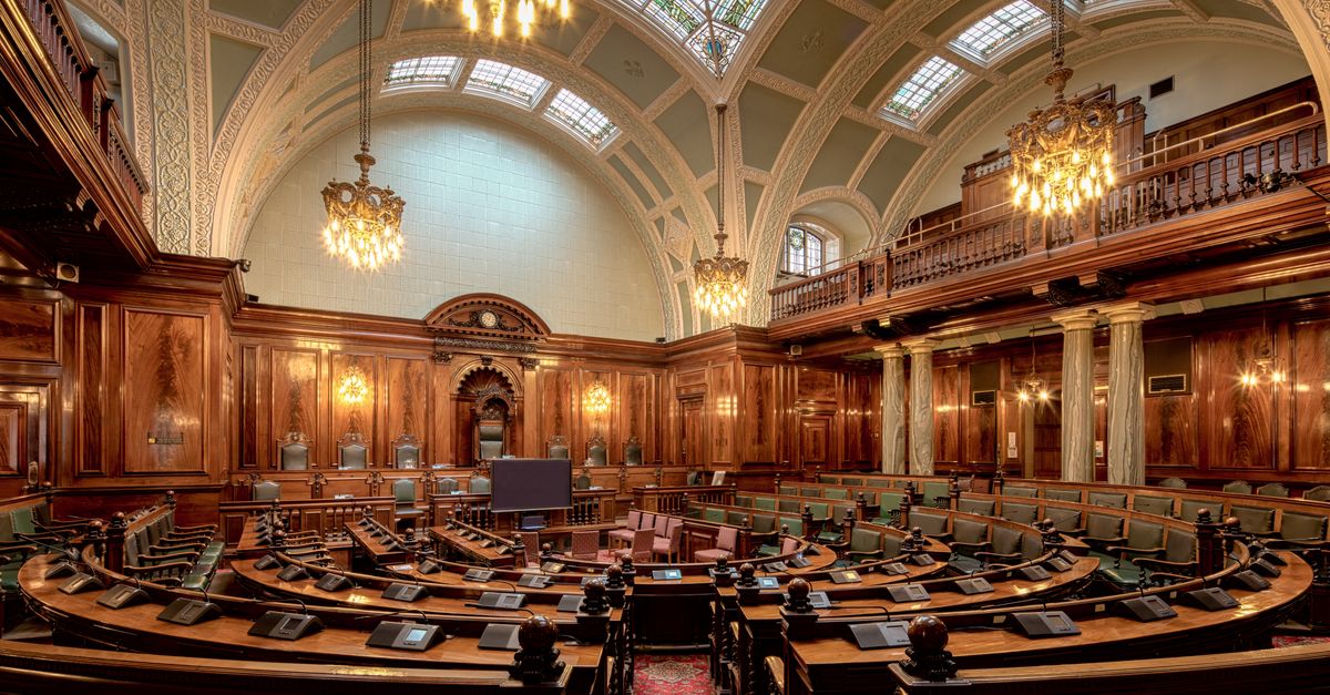 A beautifully designed chamber room with ornate woodwork and chandeliers in the UK.