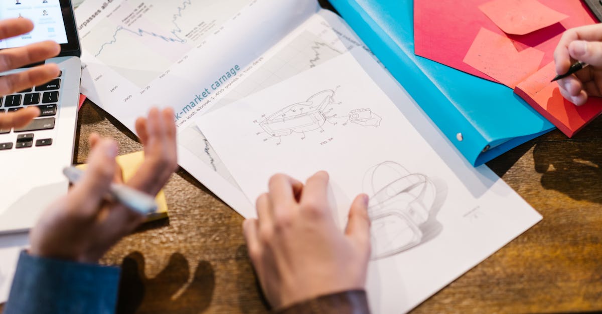 Team working on innovative design with graphs and charts in modern office setting.