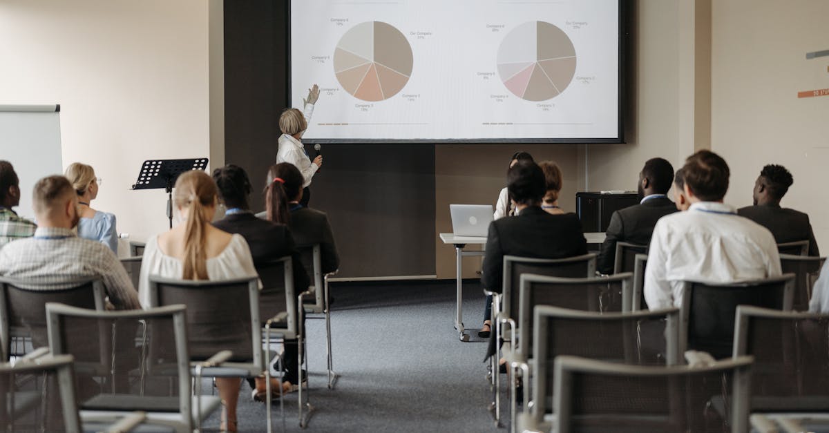 Business conference with diverse audience and speaker presenting market data.