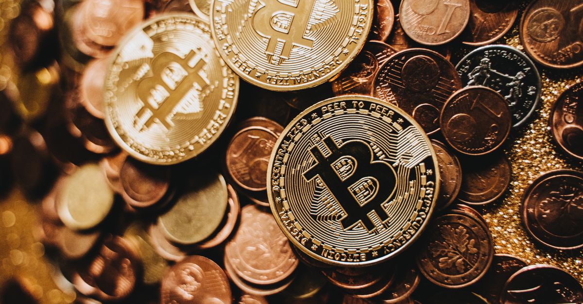 A detailed close-up of shiny bitcoins and assorted coins symbolizing digital currency and wealth.