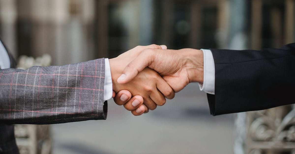 A close-up of two businesspeople shaking hands, symbolizing cooperation and partnership.