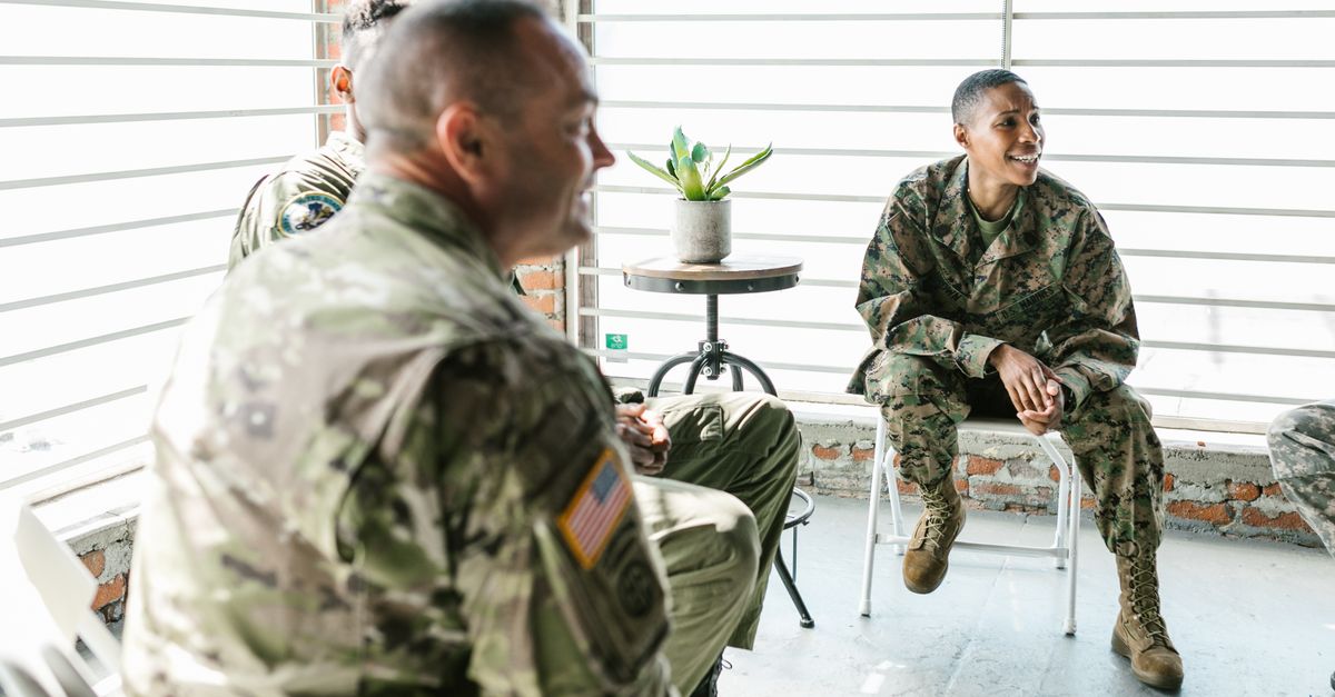 A group of military veterans in a supportive therapy session, fostering healing and togetherness.