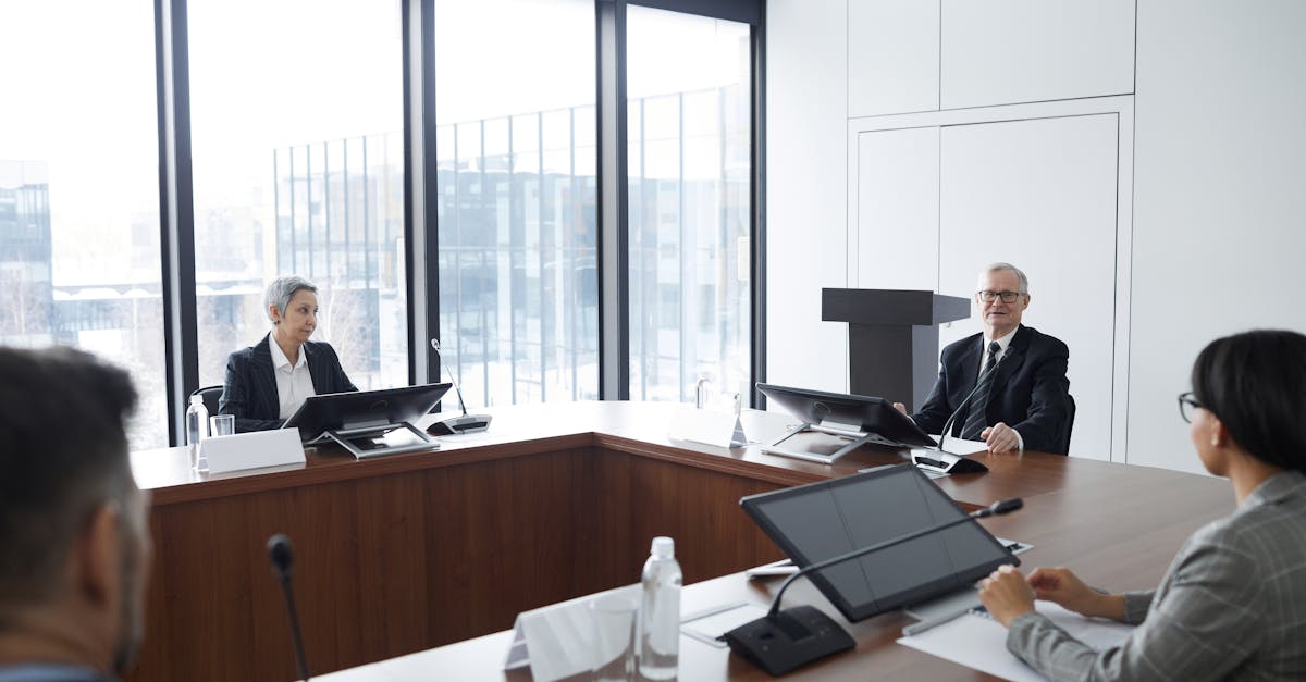 Business professionals in a board meeting in a modern conference room, engaging in discussion.