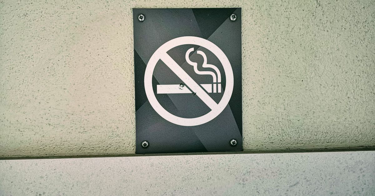 No smoking sign prominently displayed on a textured wall in London, England. Perfect for public safety themes.