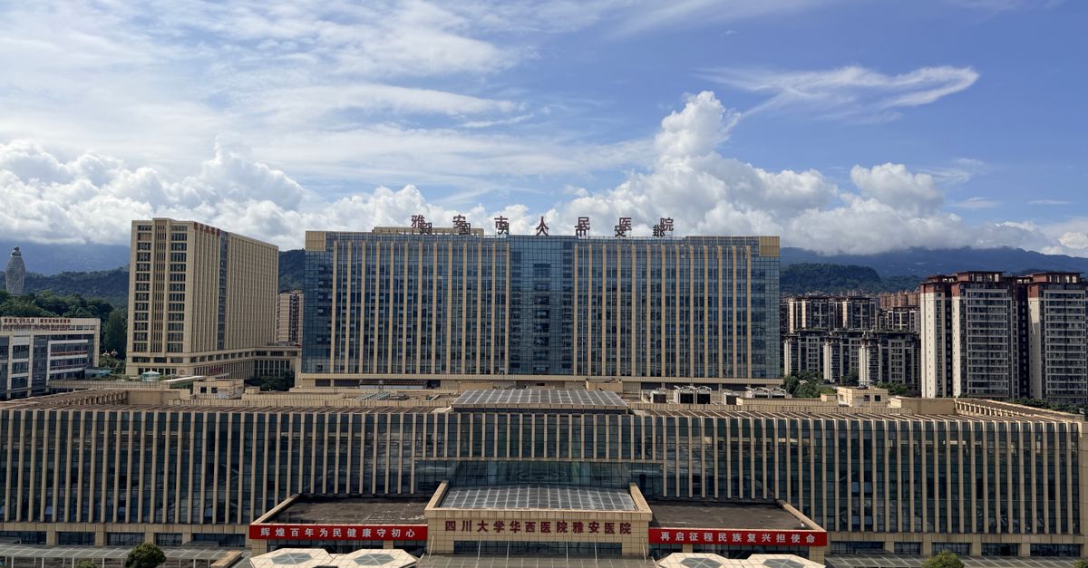 Aerial view of contemporary architecture in a Chinese city under a bright blue sky.
