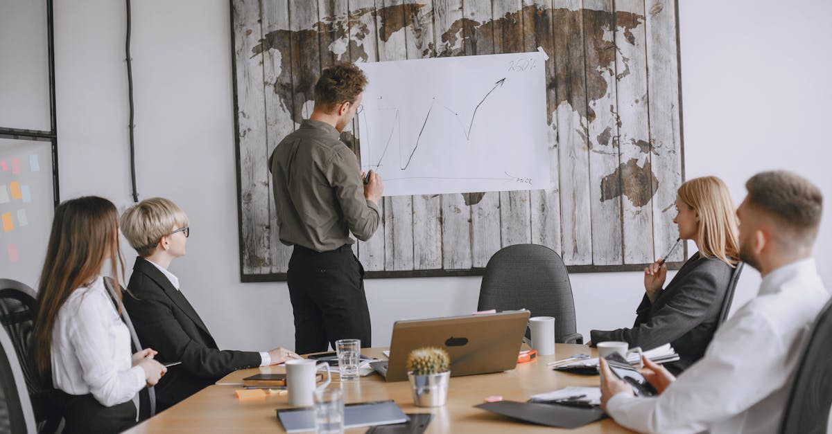 Group of business professionals discussing strategies with growth chart in conference room.