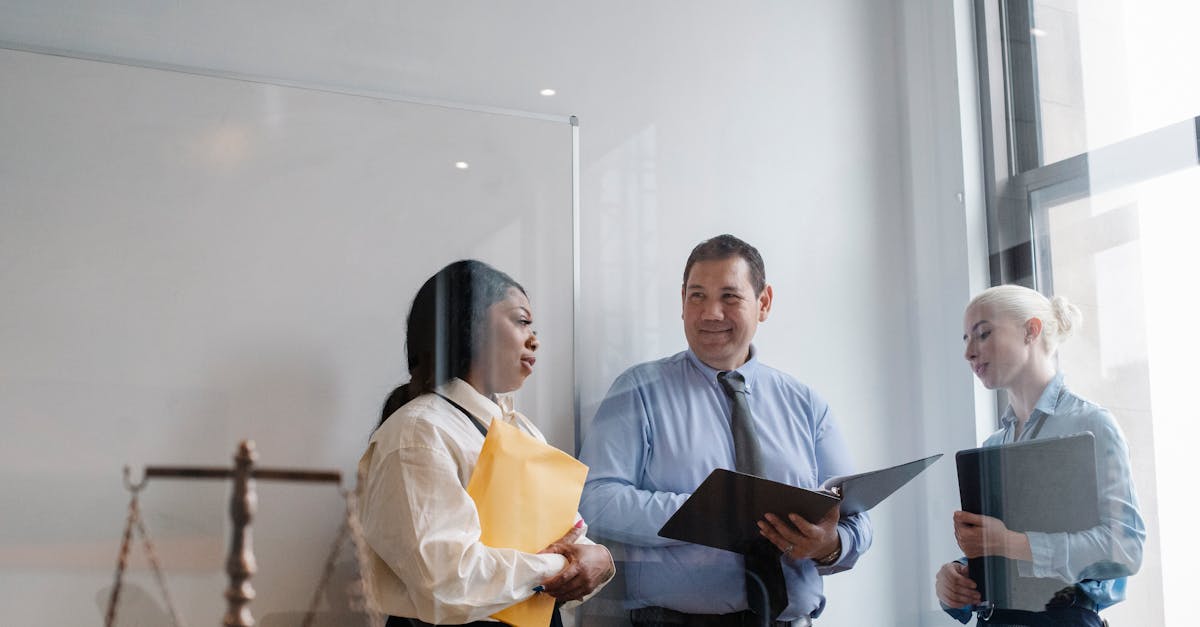 A diverse group of legal professionals discuss in a modern office setting, emphasizing collaboration and teamwork.