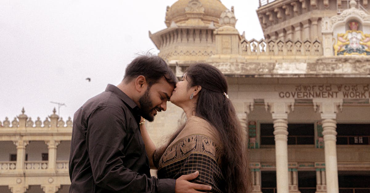A couple embracing in front of the iconic Bangalore Palace, showcasing a moment of love and architectural beauty.
