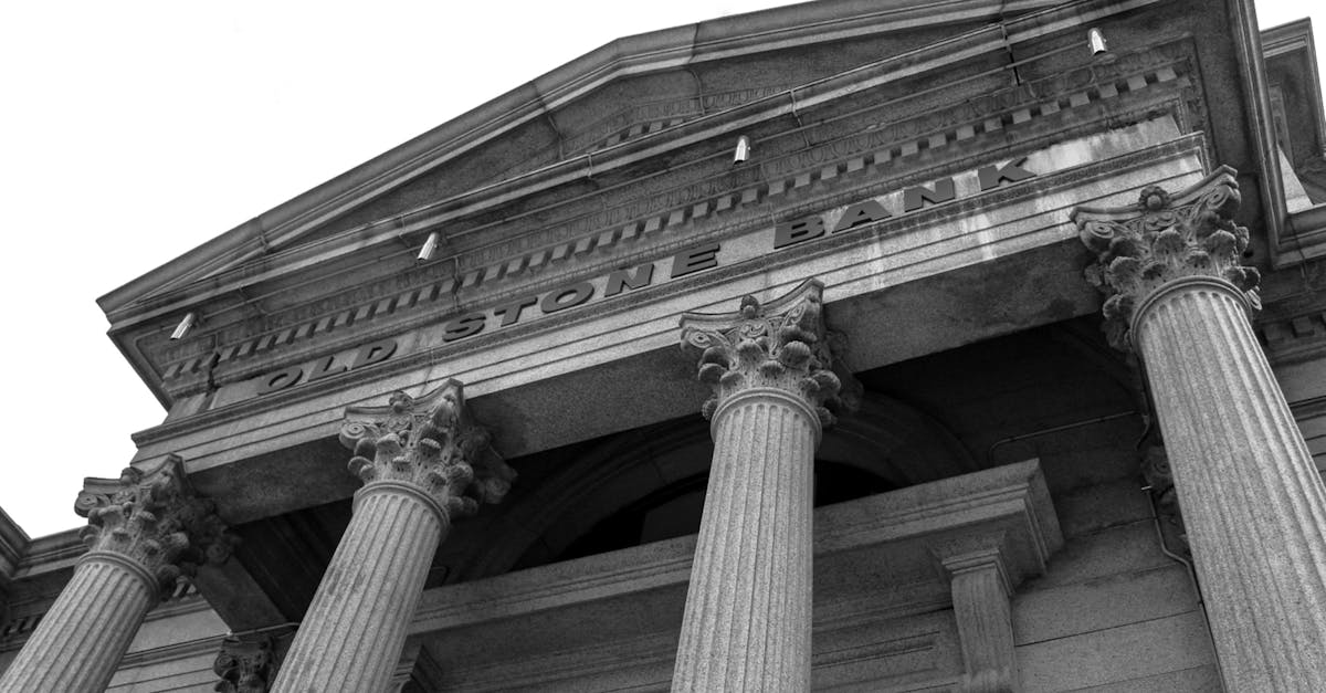 Black and white photo of the historic Old Stone Bank showcasing classical columns and architectural detail.