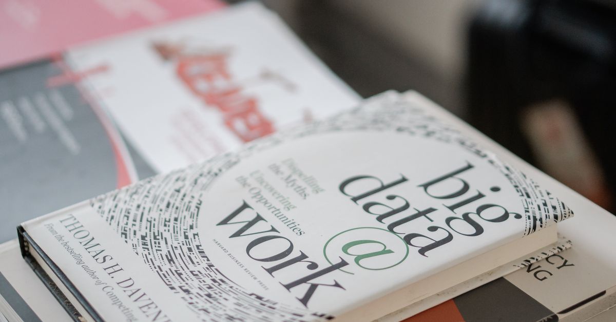 Close-up of books on data analytics and business strategies on a desk.
