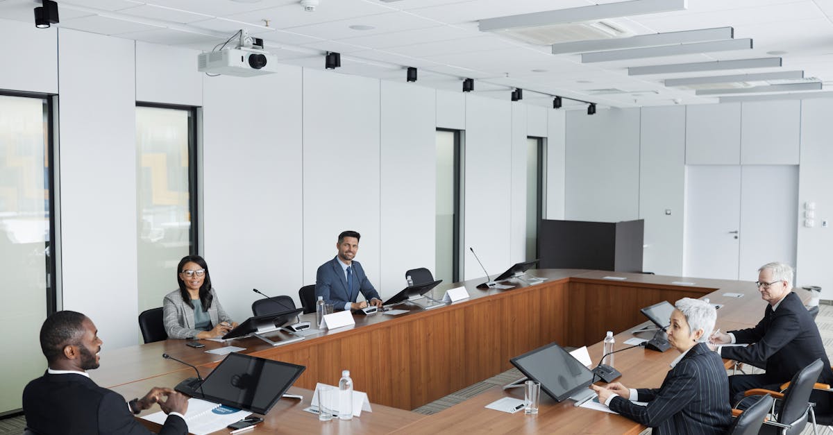 A multicultural group of professionals engaged in a business meeting in a modern conference room.