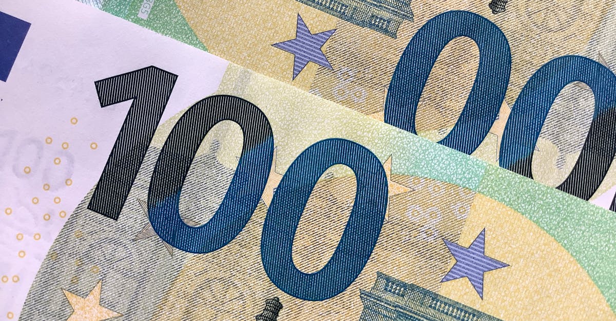 Detailed view of overlapping 100 Euro banknotes showcasing intricate design details.