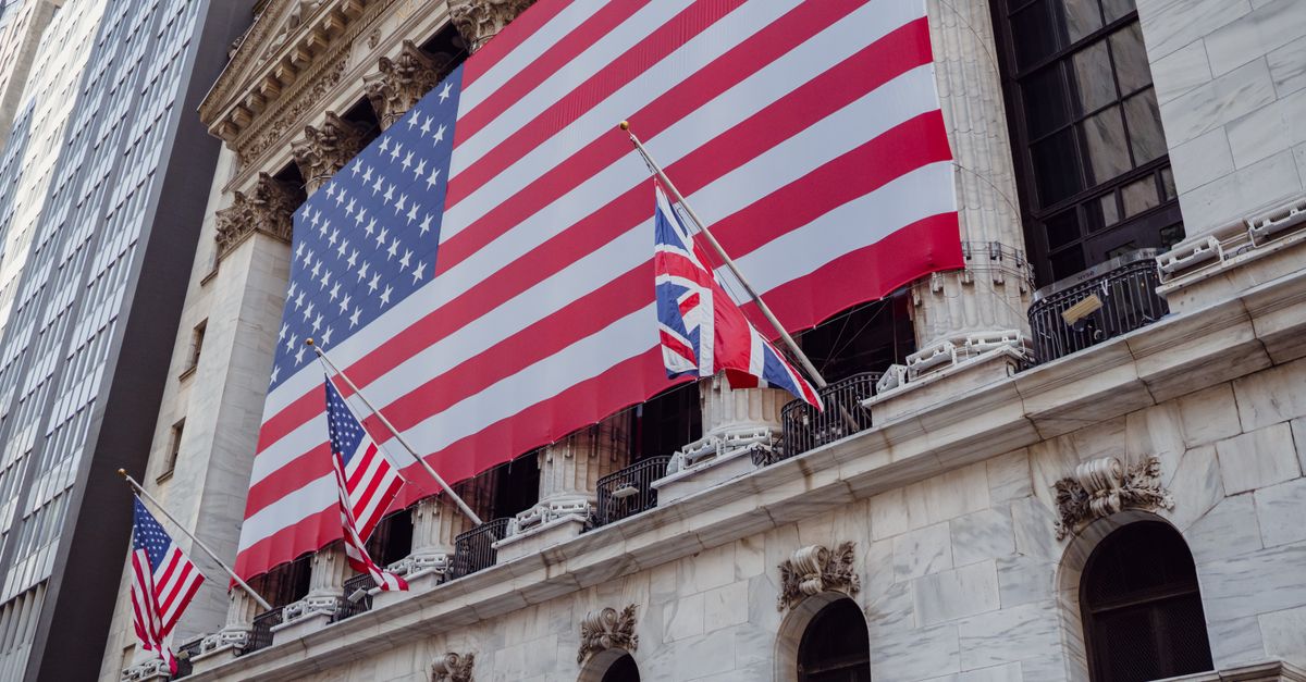 American flag on a historic building exterior symbolizing patriotism and national pride.