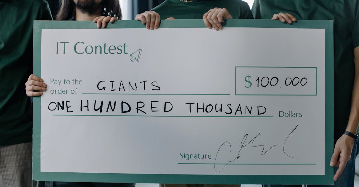Group of men holding a $100,000 prize check after winning an IT contest.