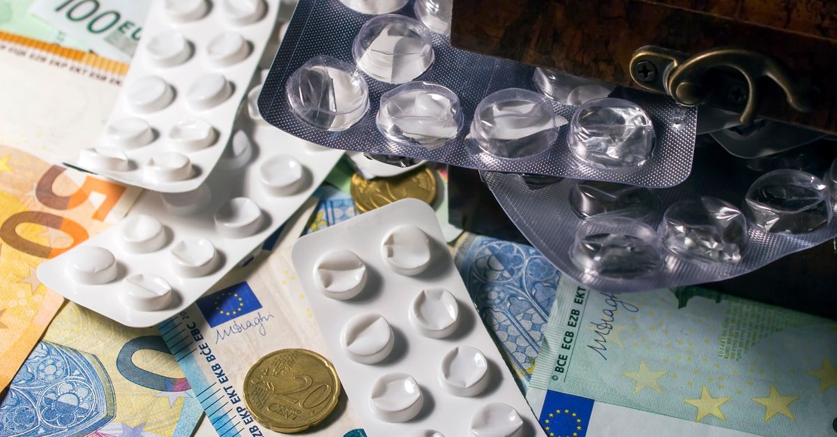 Blister packs of medication placed on Euro banknotes, illustrating healthcare expenses.