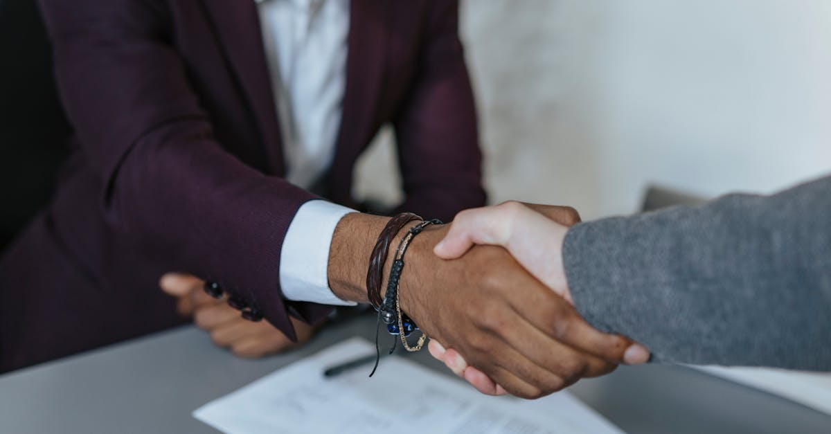 Close-up of a business handshake symbolizing agreement and partnership indoors.