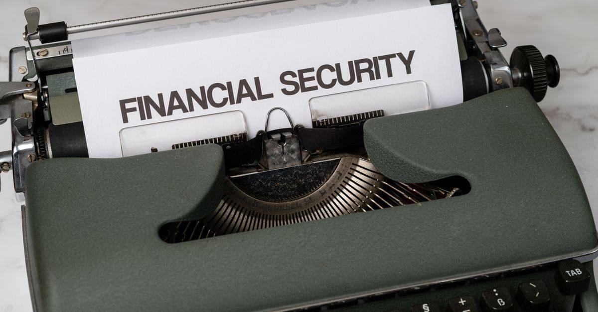 Close-up of a vintage typewriter with 'Financial Security' typed on paper, representing financial themes.